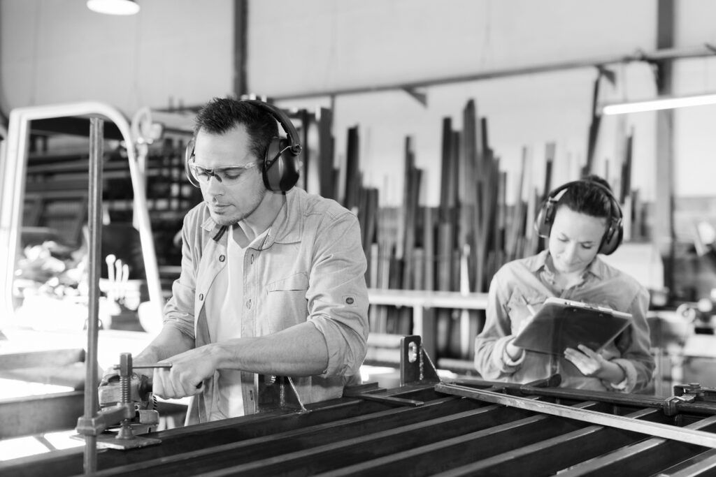 Happy man and woman in factory